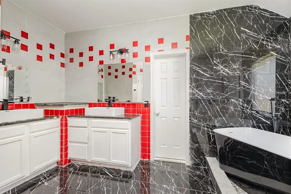 a utility room with cabinets and washer