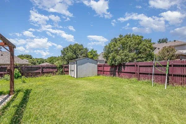 a backyard of a house with table and chairs