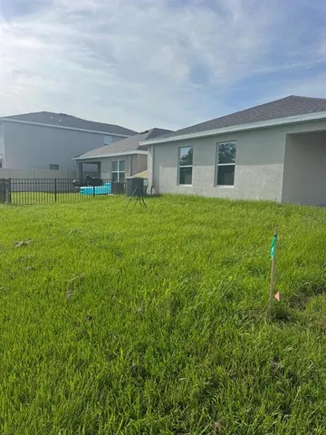 a backyard of a house with lots of green space