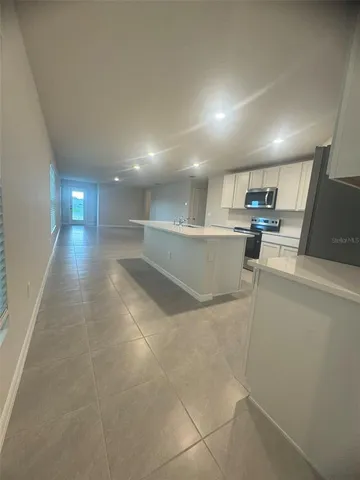 a view of a kitchen with a sink and cabinets