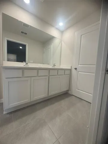 a bathroom with a double vanity sink and mirror
