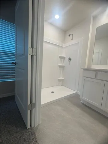 a bathroom with a bathtub and shower