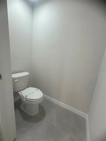 a white toilet sitting next to a white sink
