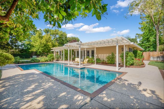 a view of a house with backyard porch and sitting area