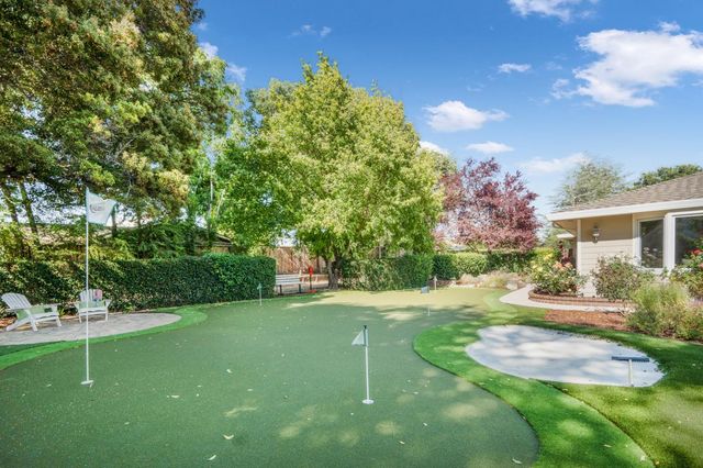 a backyard of a house with table and chairs