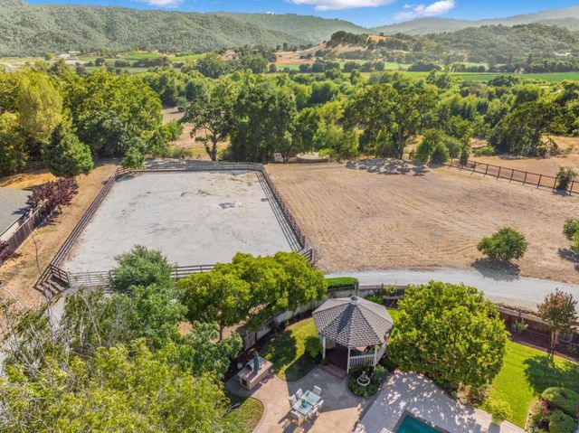 an aerial view of a house with a yard