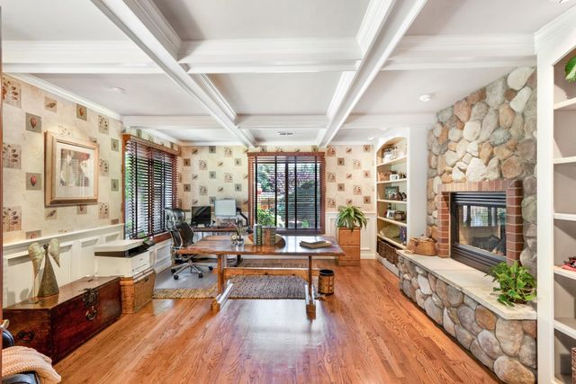 a living room with furniture large windows wooden floor and large windows