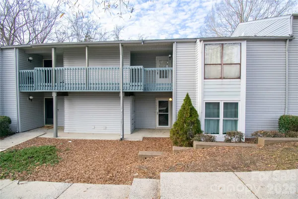 a view of a house with large windows and garage