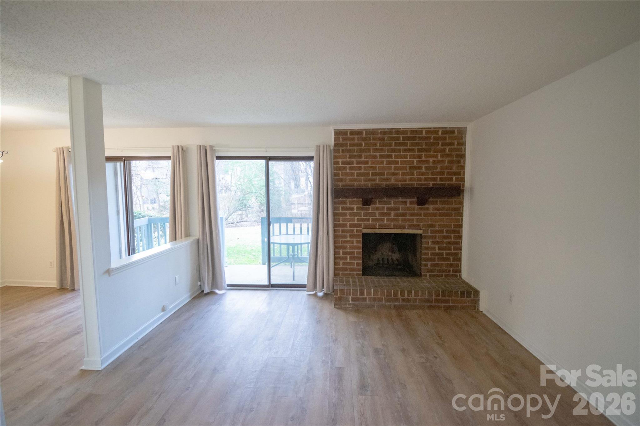 11042 Harrowfield Road Charlotte, NC 28226 - Photo 4 of 14 wooden floor fireplace and natural light in room