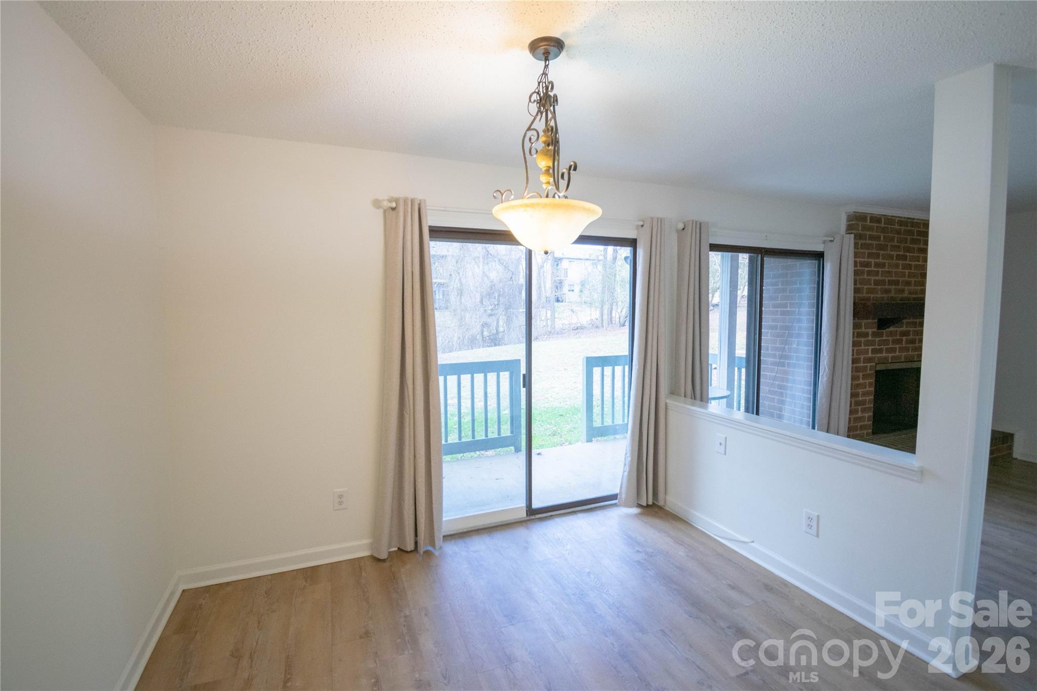 11042 Harrowfield Road Charlotte, NC 28226 - Photo 7 of 14 a view of a room with wooden floor water heater and a window
