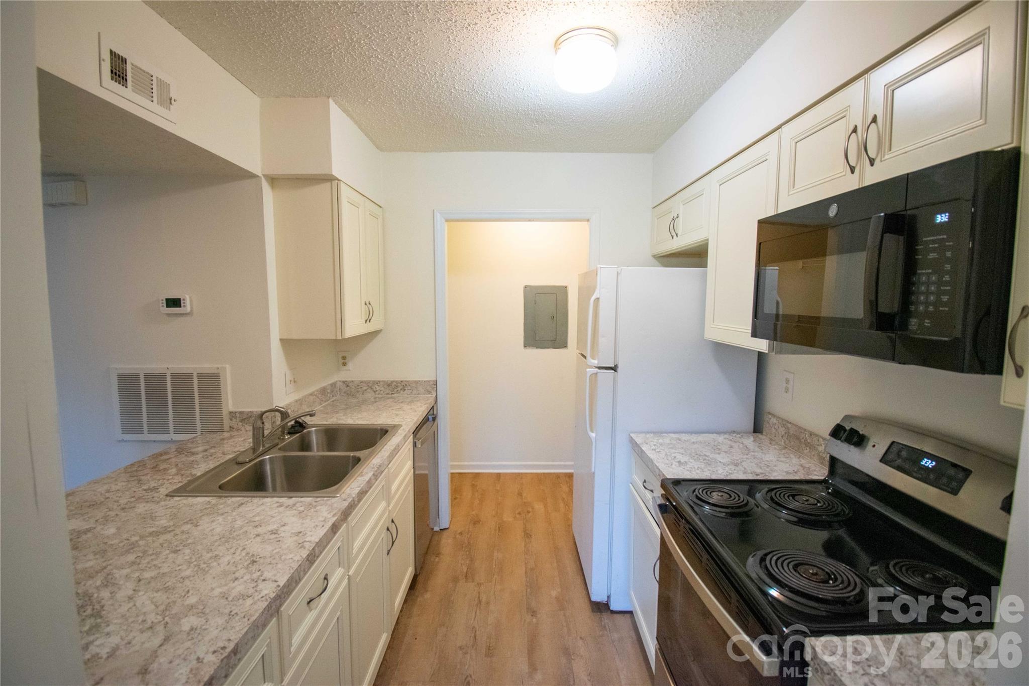 11042 Harrowfield Road Charlotte, NC 28226 - Photo 8 of 14 a kitchen with a stove and a sink