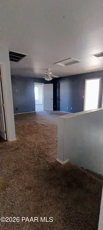 a view of a livingroom with an empty space and a window
