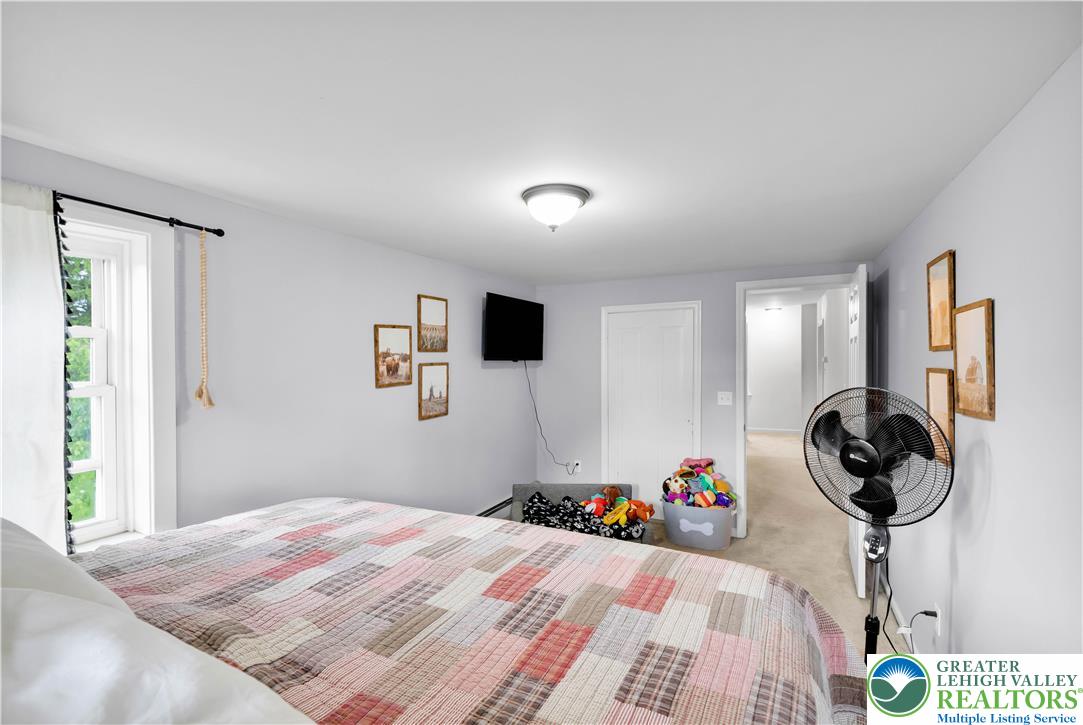 7281 Decatur Street New Tripoli, PA 18066 - Photo 13 of 24 a bed room with a bed and a chandelier