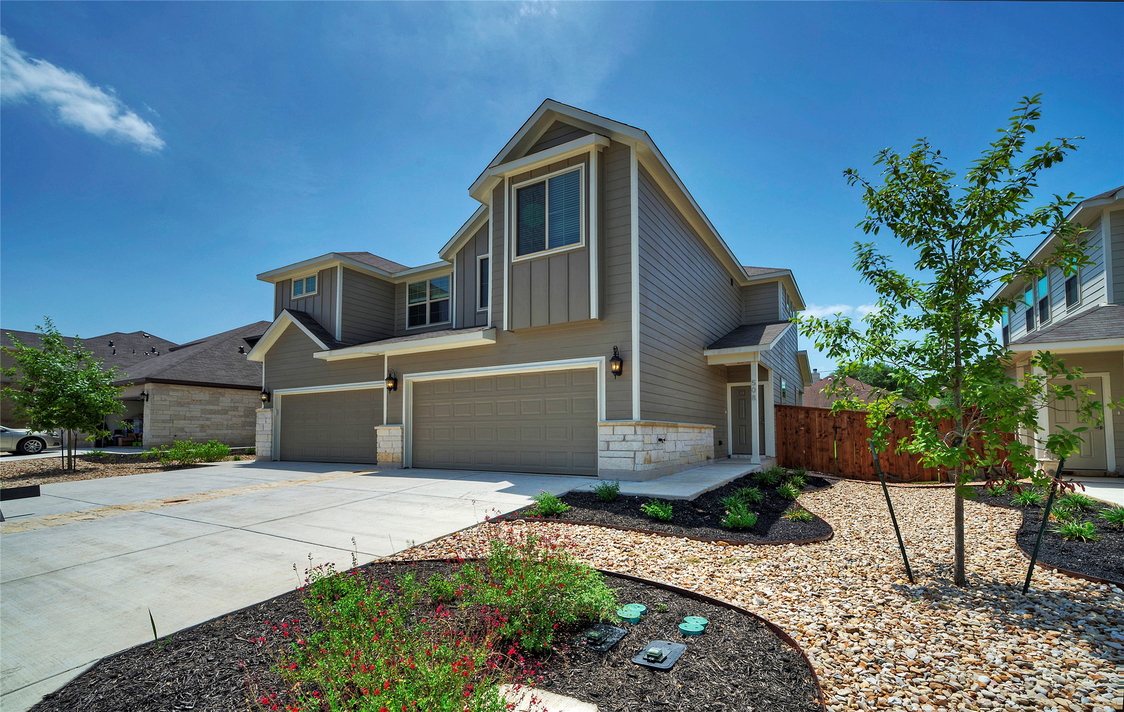 508 High Tech Drive, Unit B Georgetown, TX 78626 - Photo 2 of 24 A contemporary residence with ample garage space and well-maintained front landscaping.