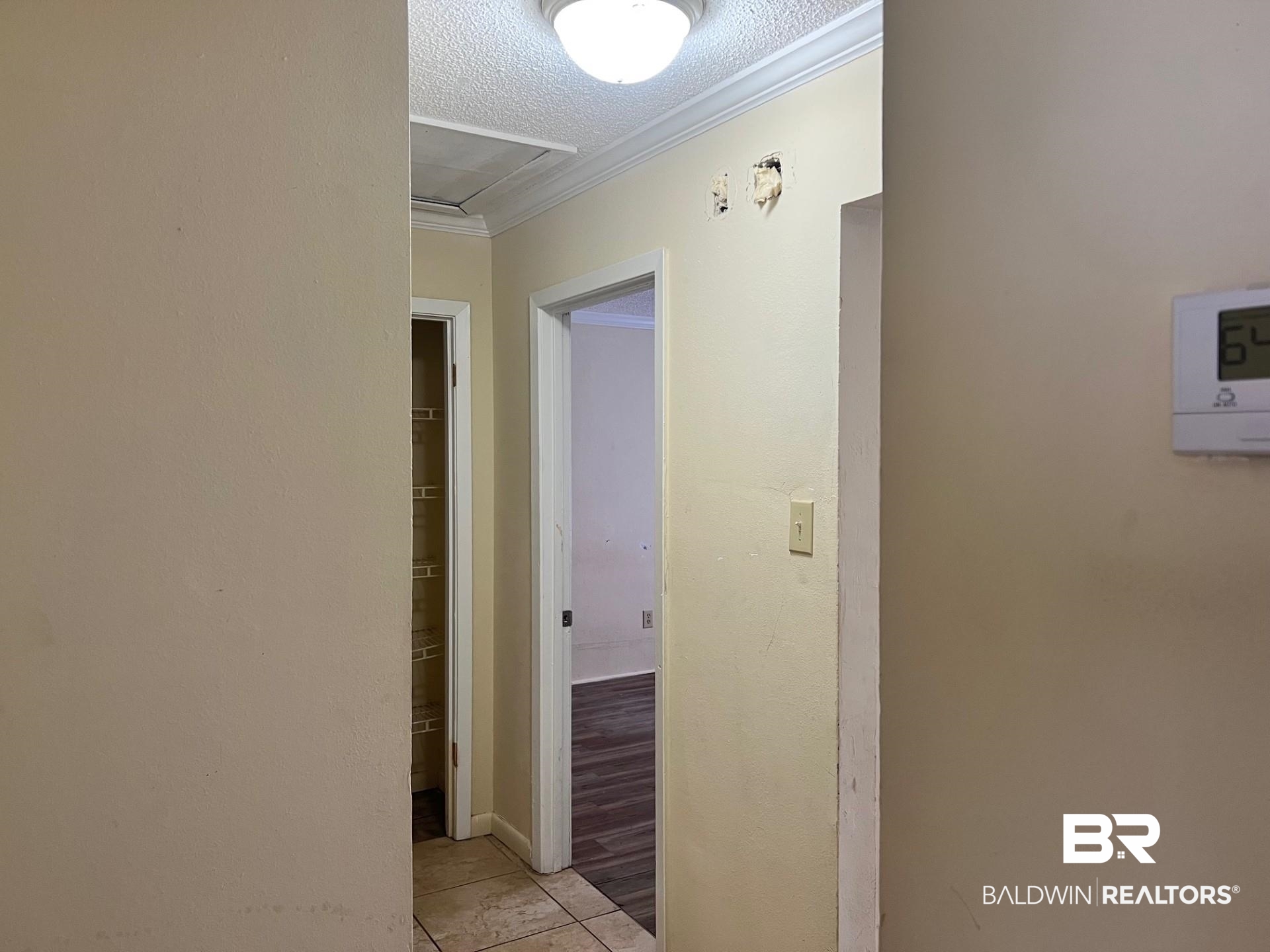 72 Grimes Lane Loxley, AL 36551 - Photo 7 of 12 Hall featuring a textured ceiling and crown molding