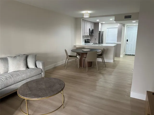 a dining room with furniture and wooden floor