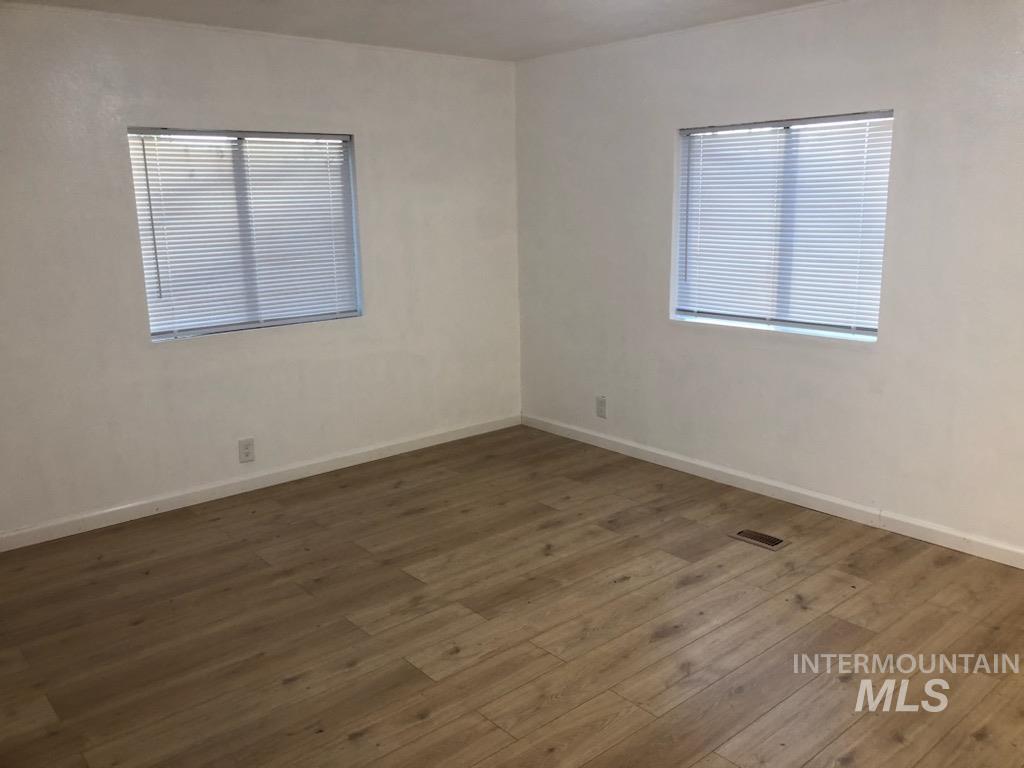 655 Dolson Lane Eagle, ID 83616 - Photo 17 of 23 Spare room featuring dark wood-type flooring and baseboards