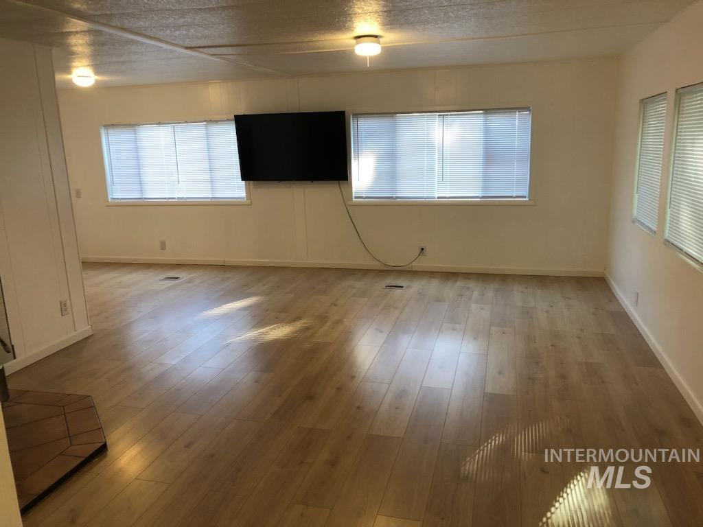 655 Dolson Lane Eagle, ID 83616 - Photo 2 of 23 Empty room with light wood-style floors and baseboards