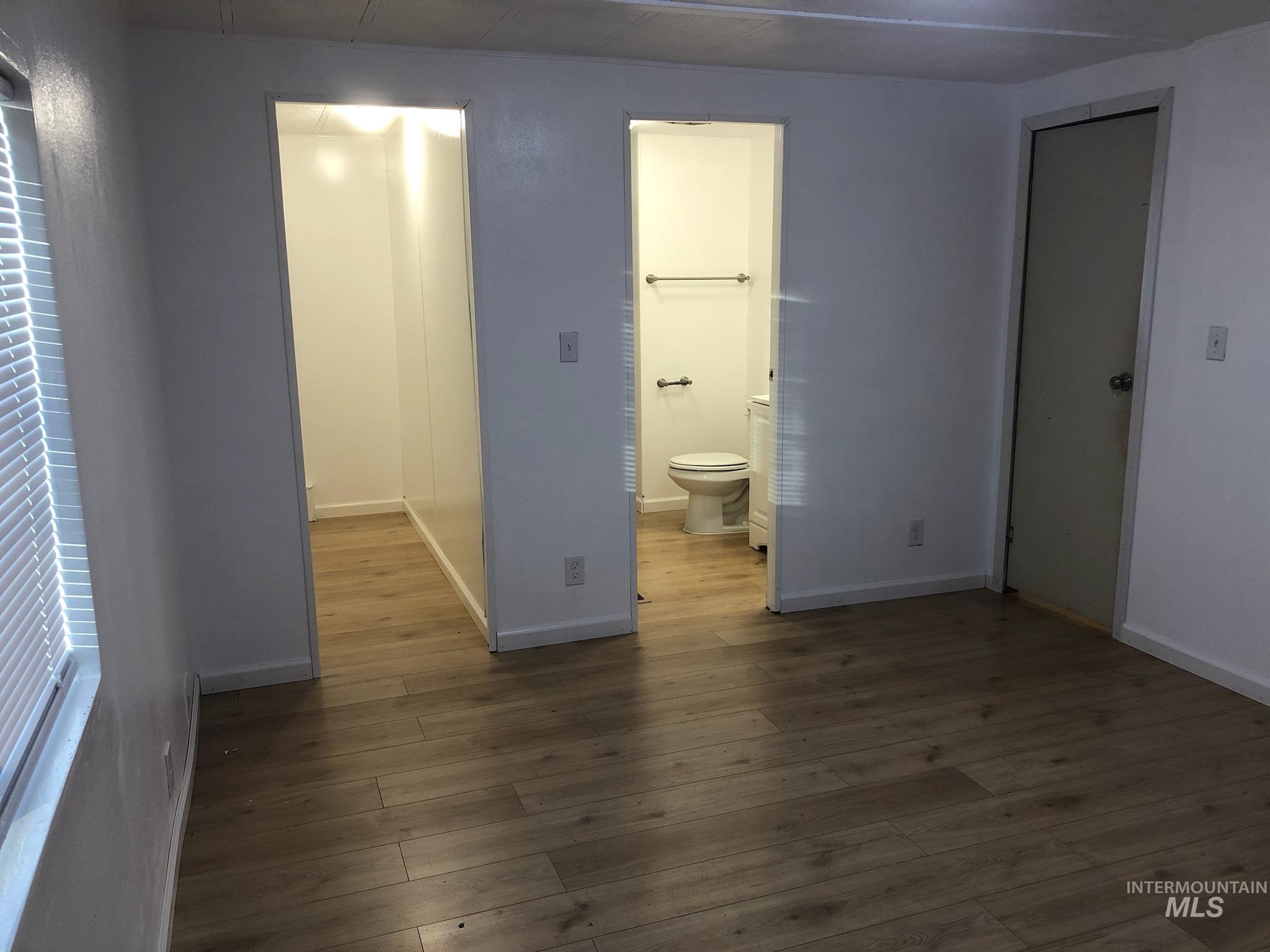 655 Dolson Lane Eagle, ID 83616 - Photo 23 of 23 Unfurnished bedroom featuring dark wood finished floors and connected bathroom