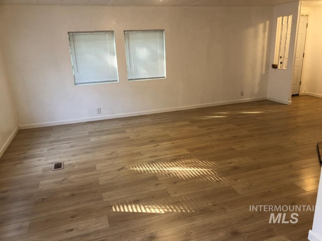 655 Dolson Lane Eagle, ID 83616 - Photo 3 of 23 Empty room with wood finished floors