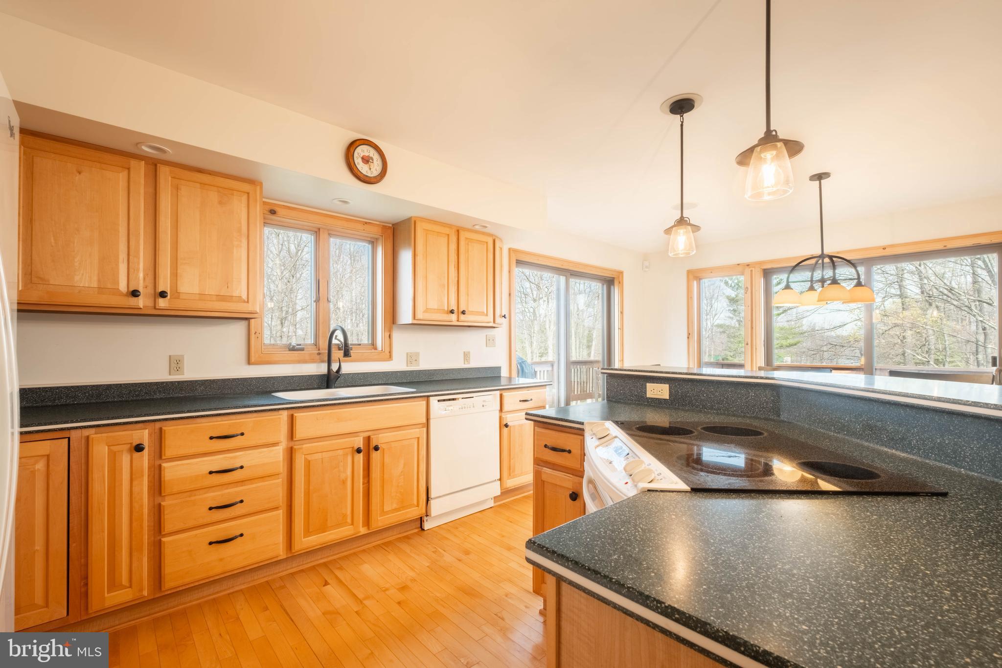 128 Bridgeview Lane Swanton, MD 21561 - Photo 11 of 70 a kitchen with granite countertop a sink a stove and cabinets