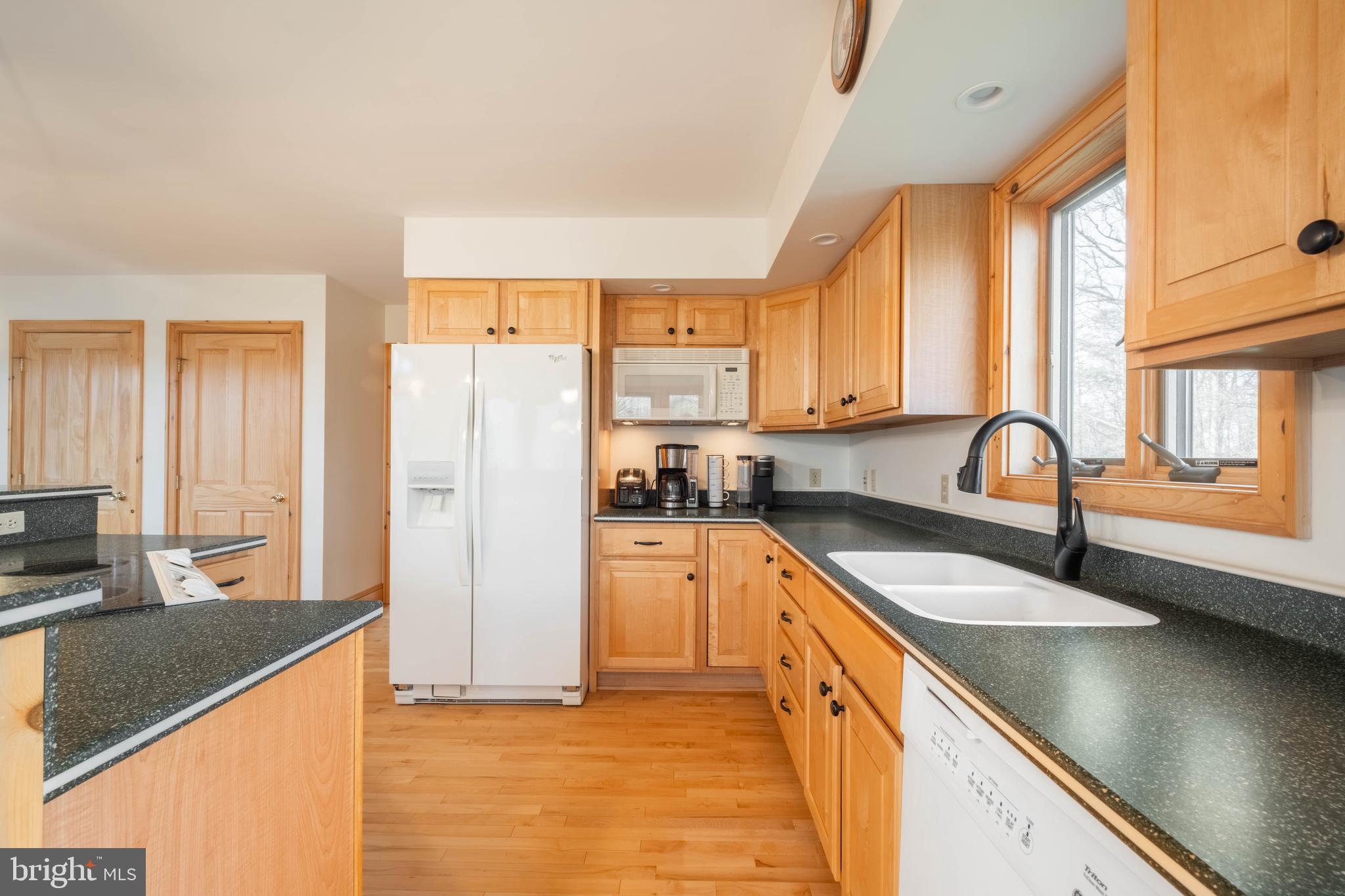 128 Bridgeview Lane Swanton, MD 21561 - Photo 13 of 70 a kitchen with stainless steel appliances granite countertop a sink a stove and a refrigerator
