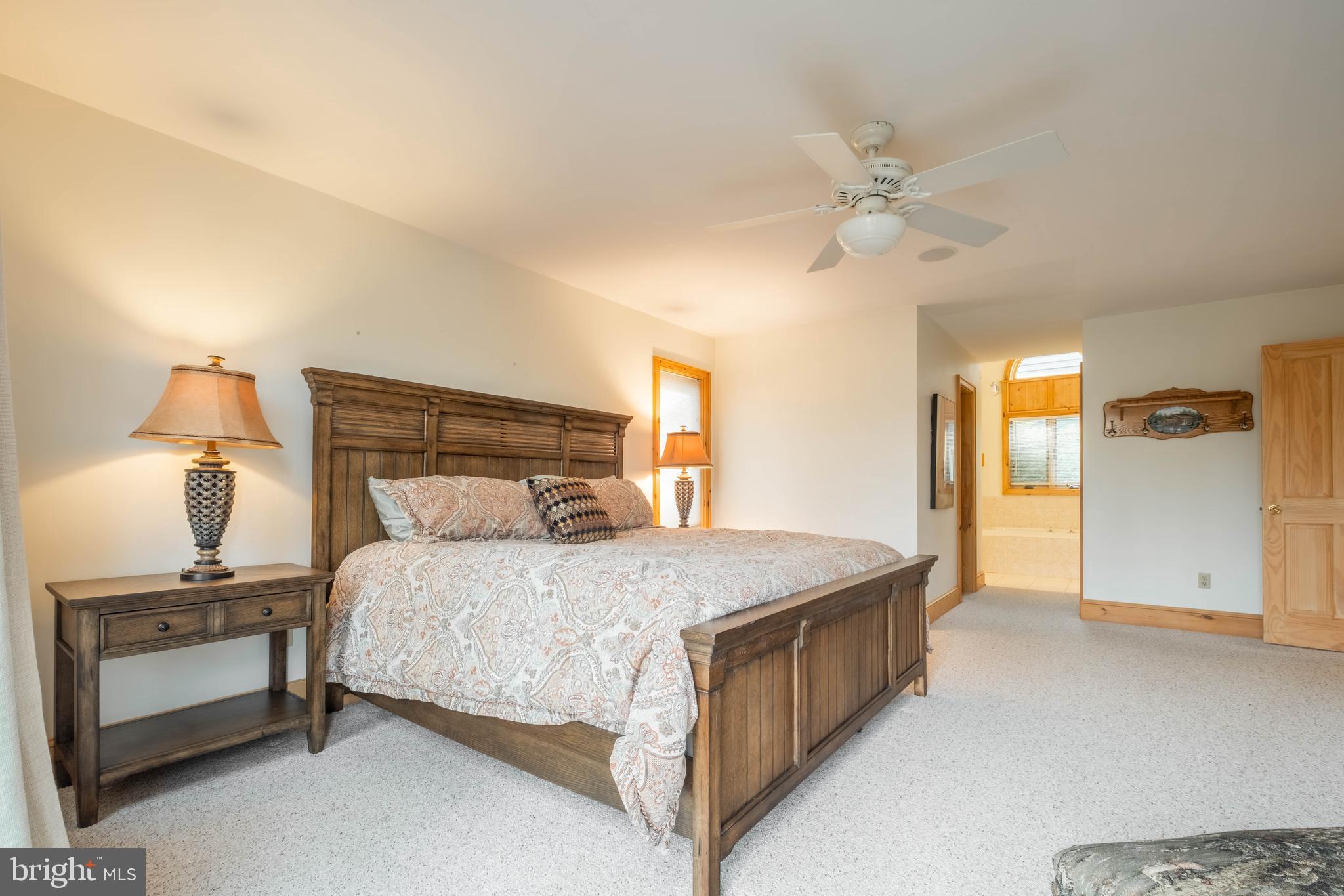 128 Bridgeview Lane Swanton, MD 21561 - Photo 18 of 70 a bedroom with a bed and a chandelier