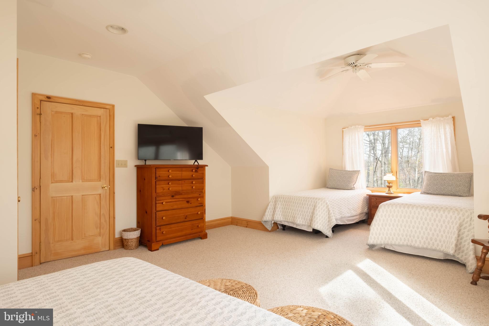 128 Bridgeview Lane Swanton, MD 21561 - Photo 30 of 70 a spacious bedroom with a bed and a couch