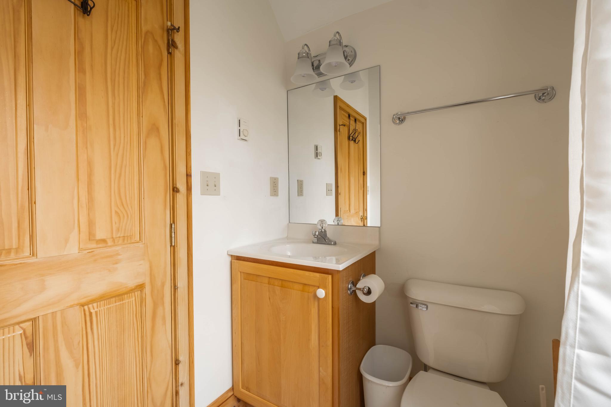 128 Bridgeview Lane Swanton, MD 21561 - Photo 45 of 70 a bathroom with a granite countertop sink and a mirror