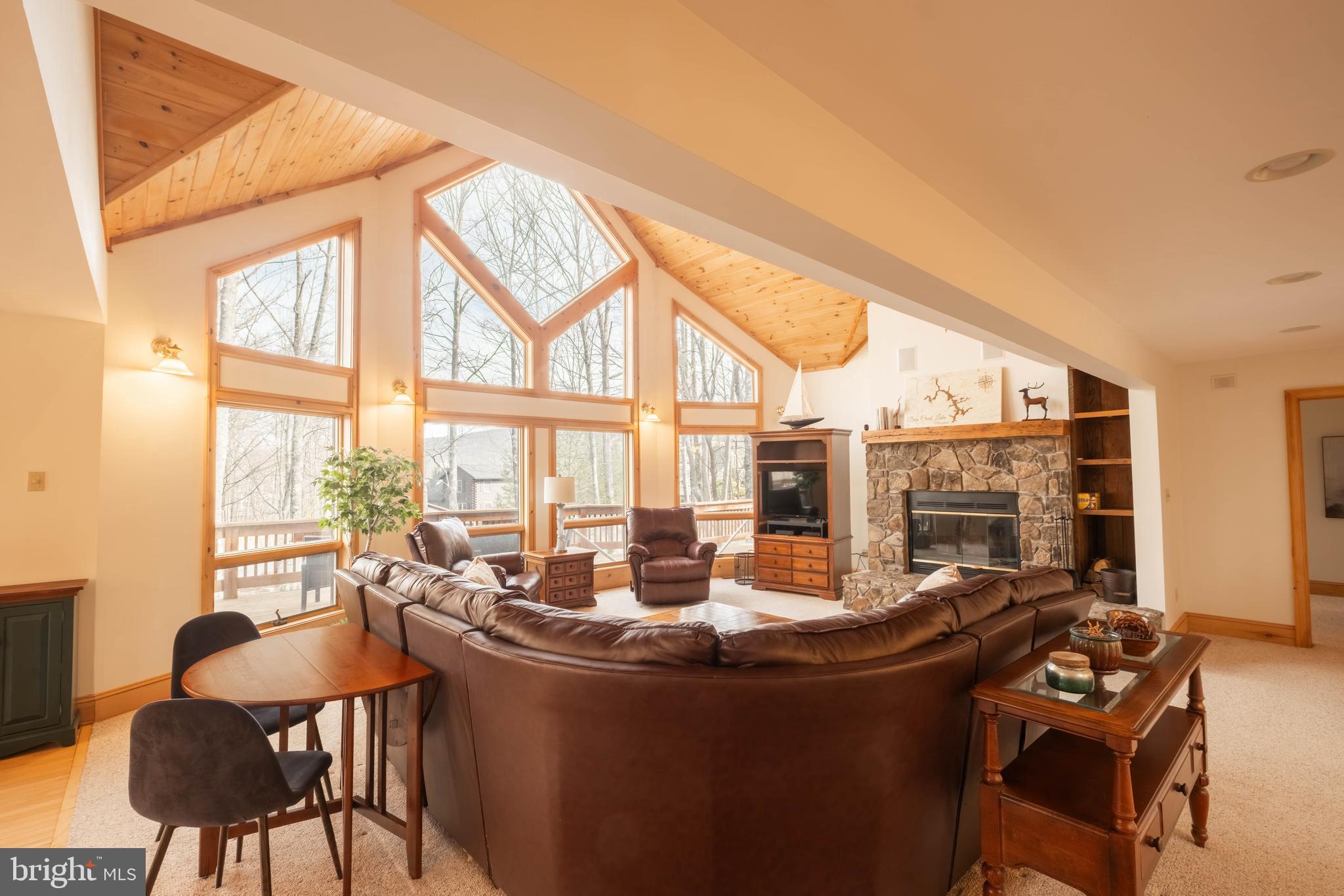 128 Bridgeview Lane Swanton, MD 21561 - Photo 5 of 70 a living room with fireplace furniture and a floor to ceiling window
