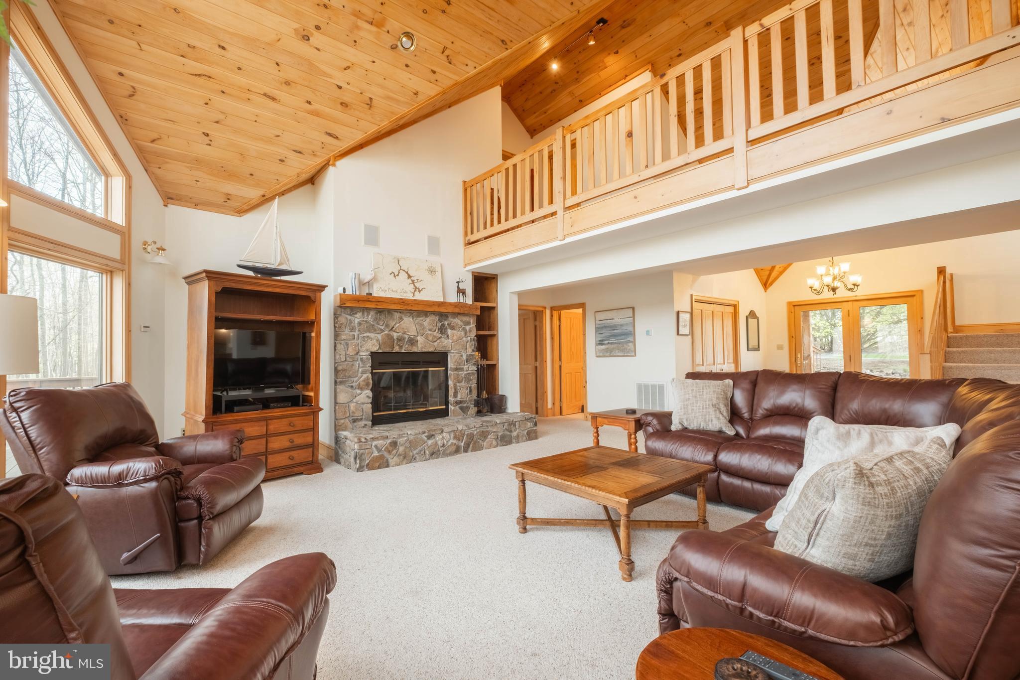 128 Bridgeview Lane Swanton, MD 21561 - Photo 6 of 70 a living room with furniture a flat screen tv and a fireplace