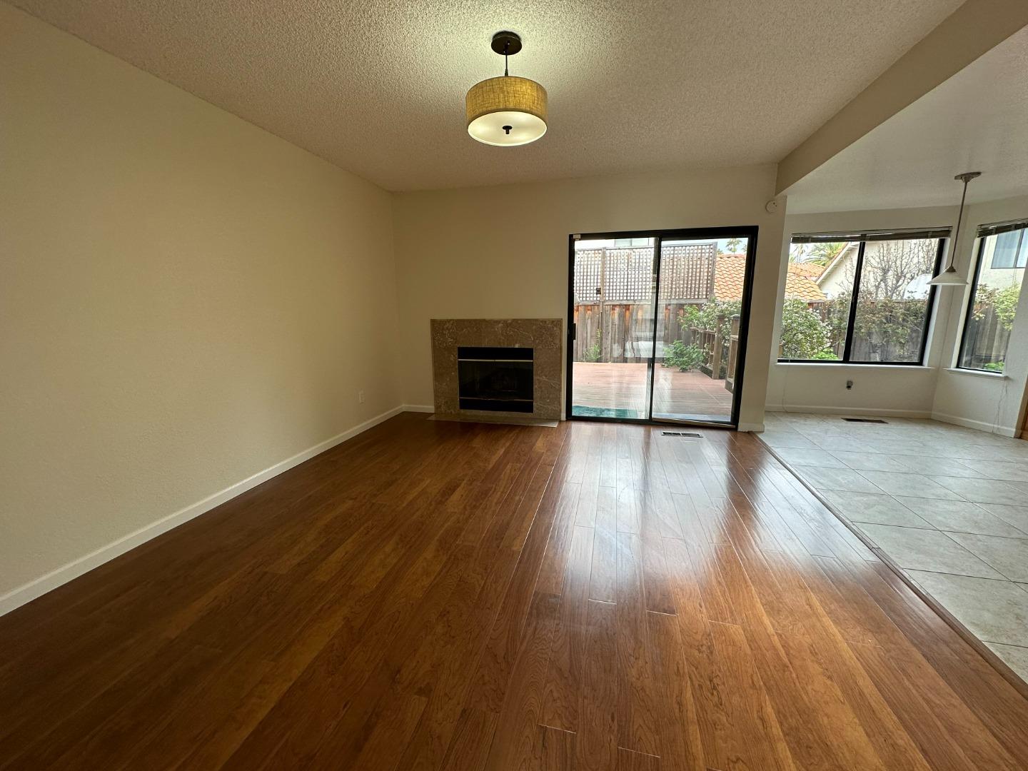 645 Kirby Common Fremont, CA 94539 - Photo 12 of 39 an empty room with wooden floor and windows
