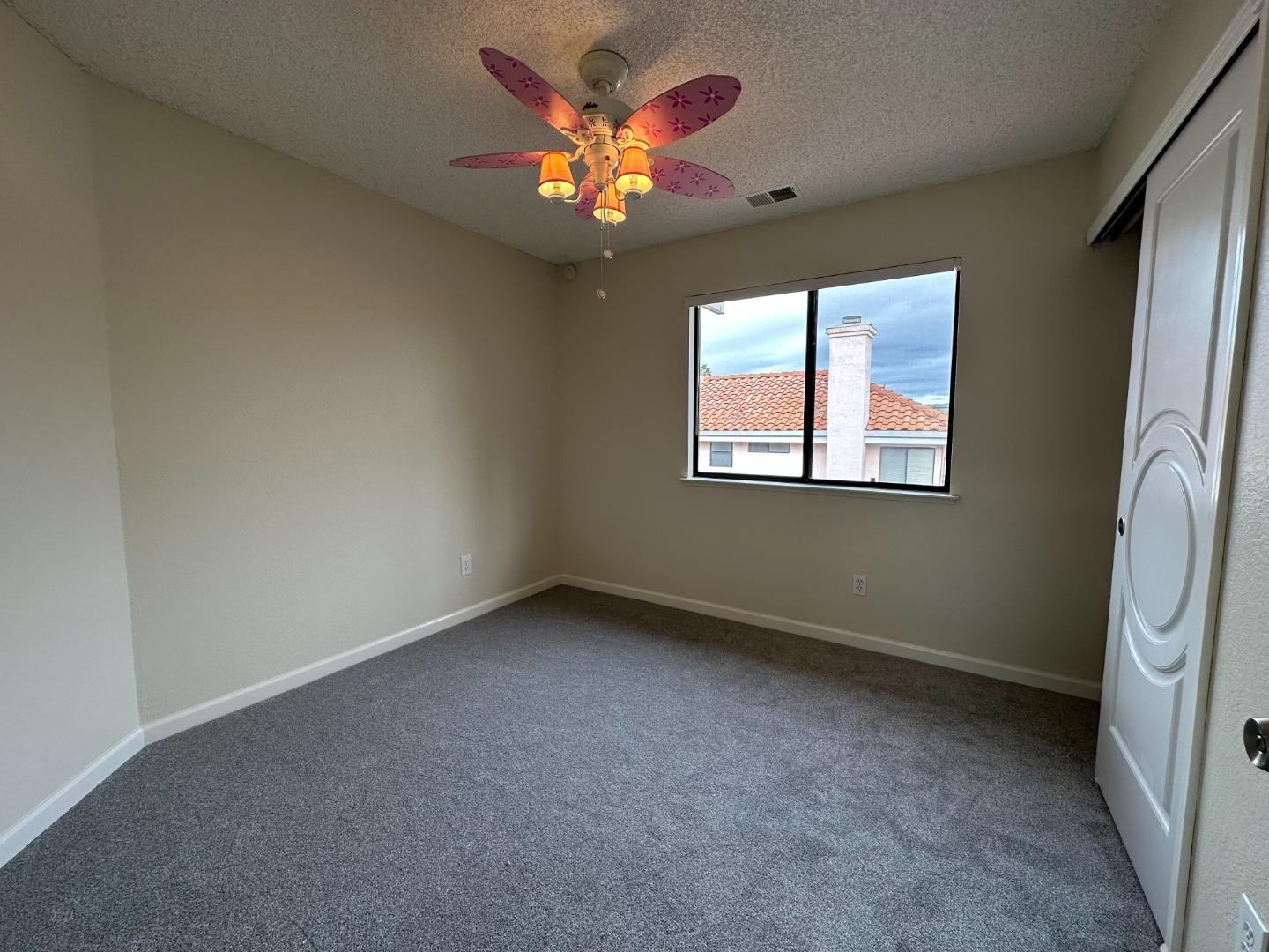 645 Kirby Common Fremont, CA 94539 - Photo 17 of 39 an empty room with windows and a ceiling fan
