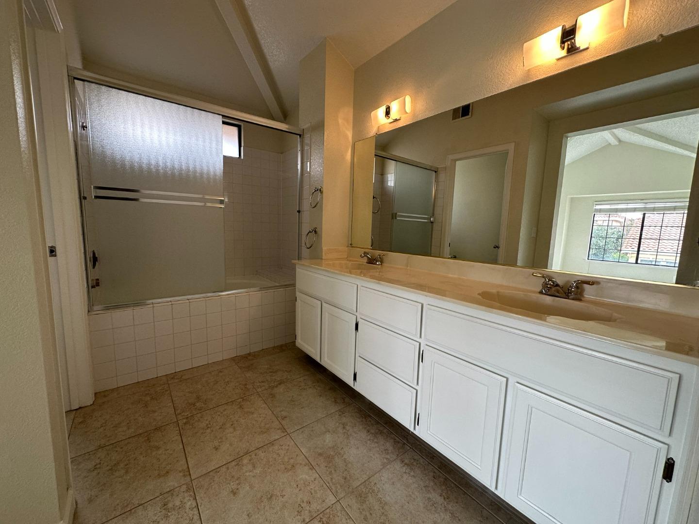 645 Kirby Common Fremont, CA 94539 - Photo 28 of 39 a bathroom with a double vanity sink and a mirror