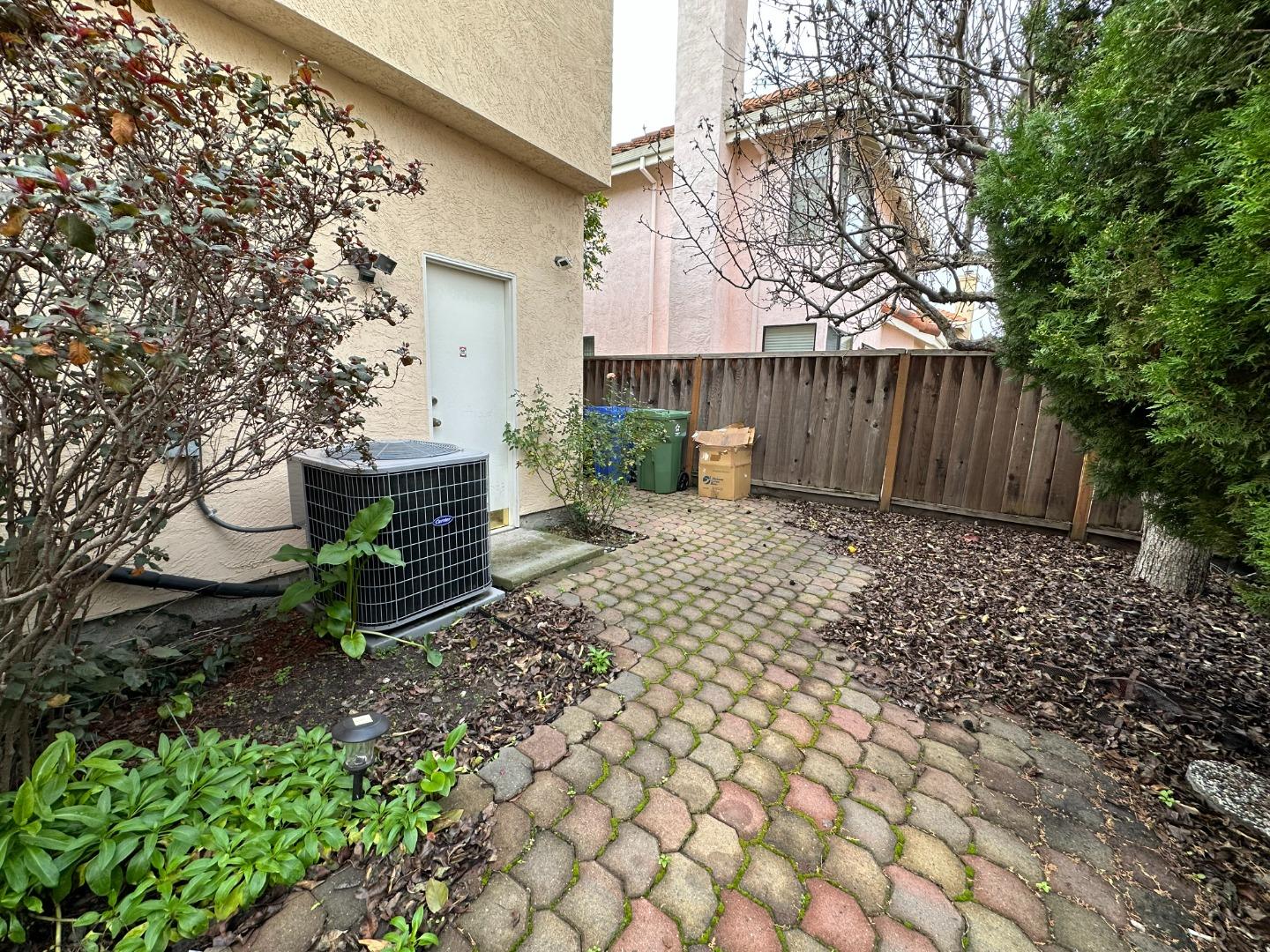 645 Kirby Common Fremont, CA 94539 - Photo 34 of 39 a view of a backyard with plants and wooden fence