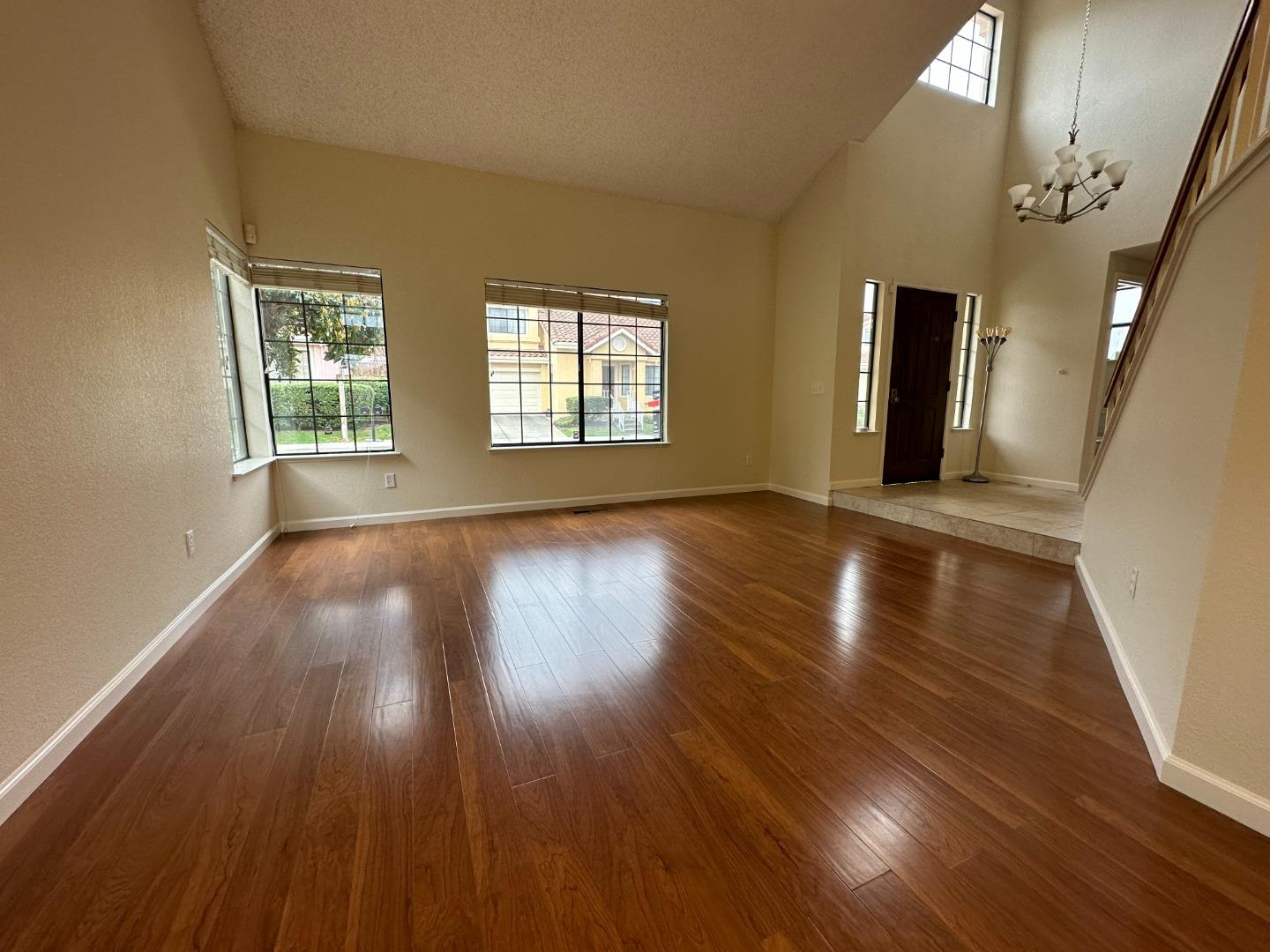 645 Kirby Common Fremont, CA 94539 - Photo 5 of 39 an empty room with wooden floor and windows