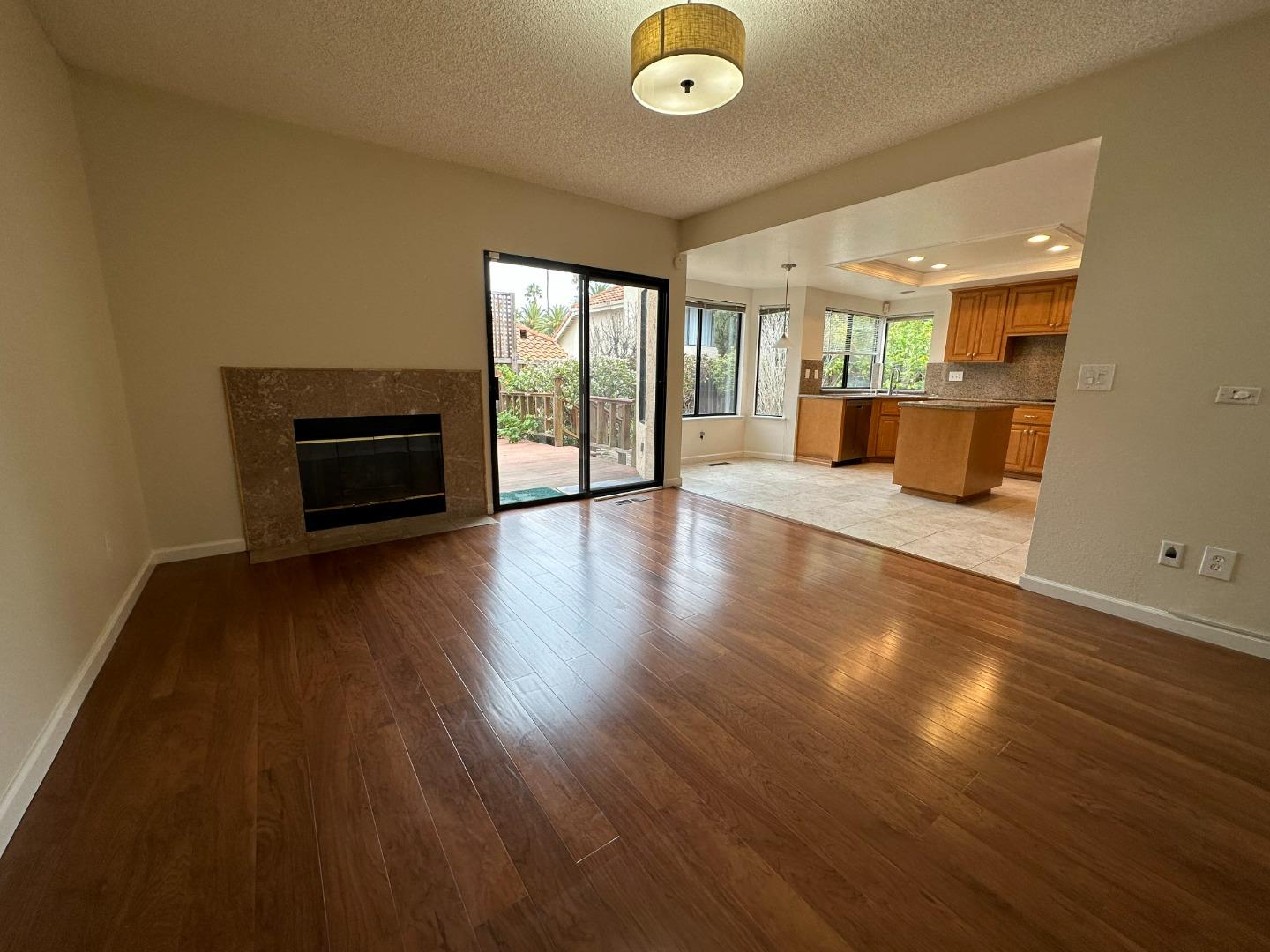 645 Kirby Common Fremont, CA 94539 - Photo 8 of 39 an empty room with wooden floor and windows