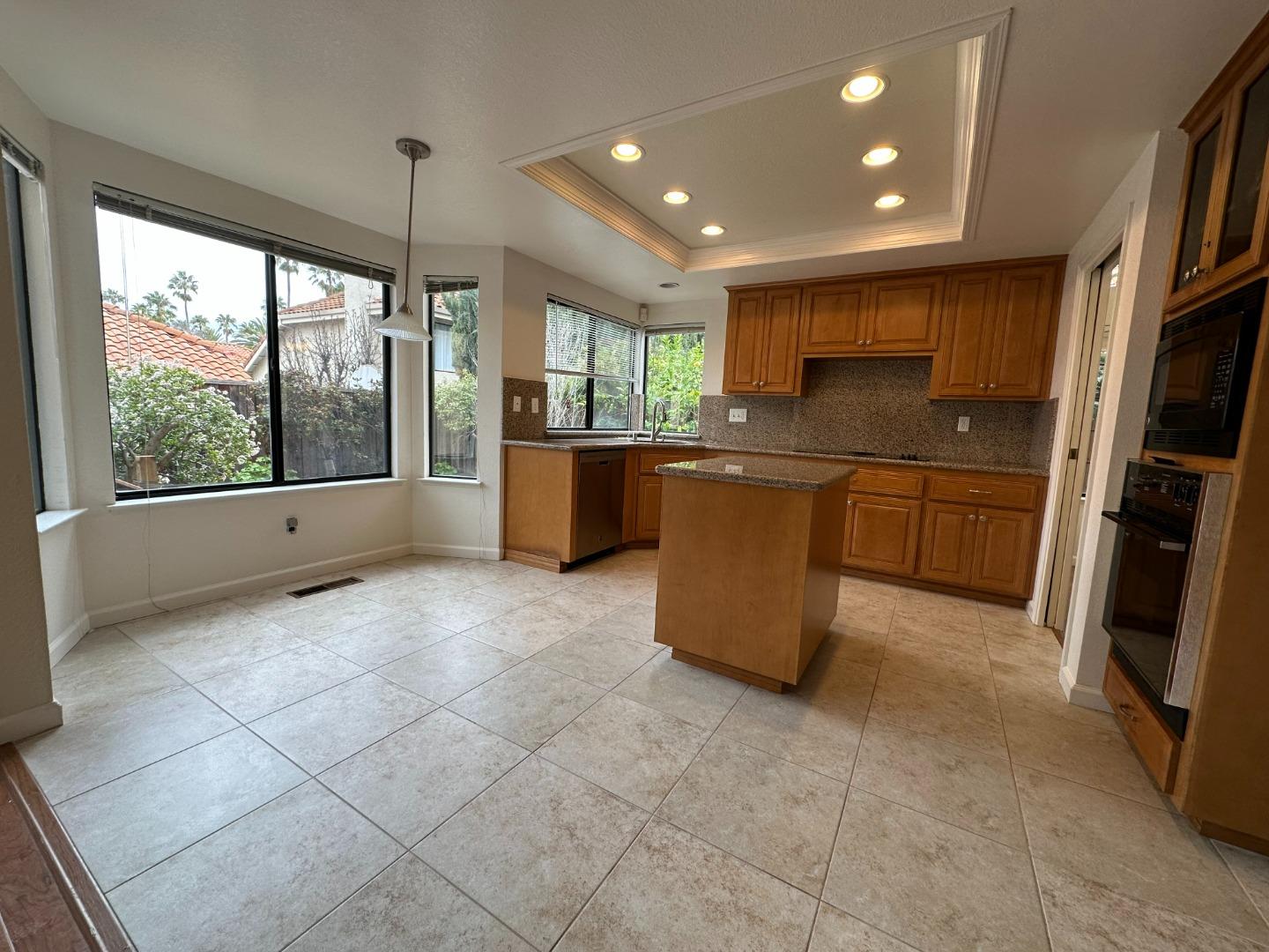 645 Kirby Common Fremont, CA 94539 - Photo 9 of 39 a kitchen with stainless steel appliances granite countertop a refrigerator and a stove top oven