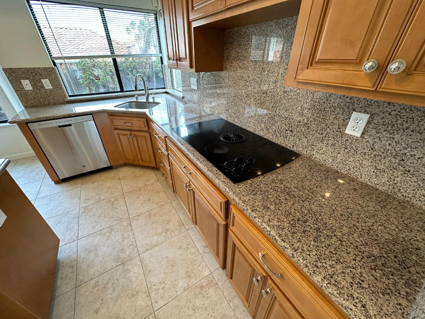 645 Kirby Common Fremont, CA 94539 - Photo 10 of 39 a kitchen with stainless steel appliances granite countertop a sink and a stove