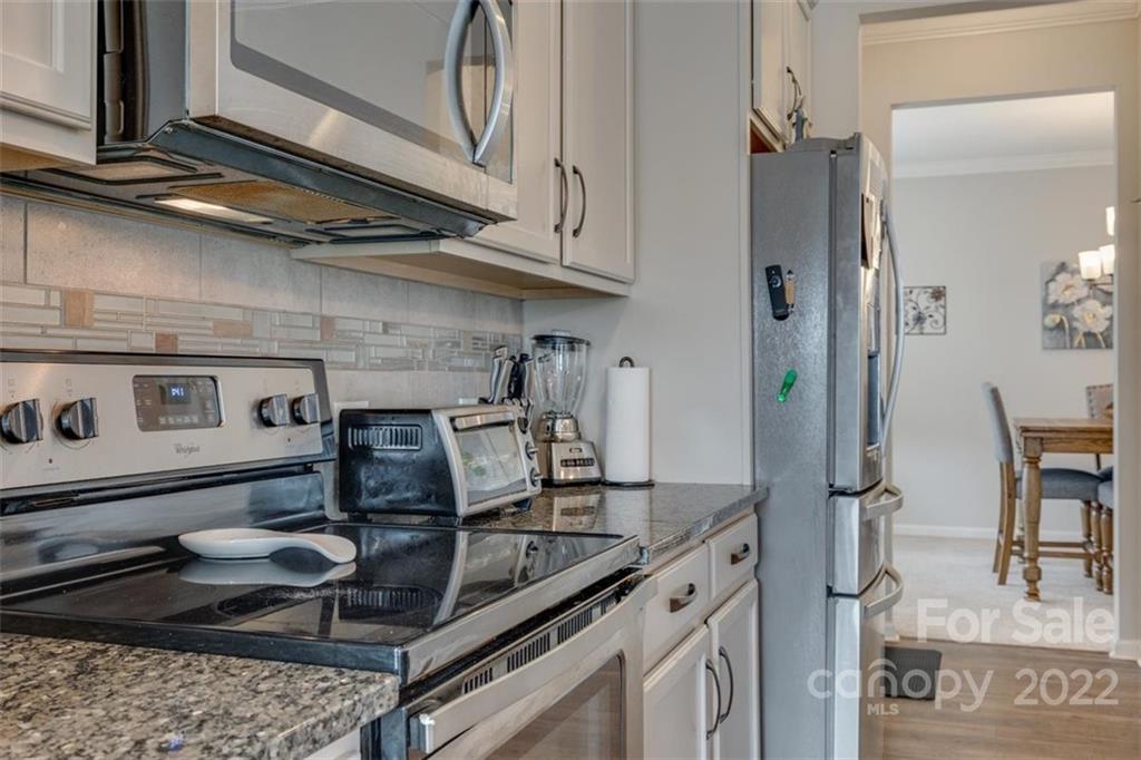 167 Old Carriage Road, Unit 226 Clover, SC 29710 - Photo 17 of 36 a kitchen with a stove and a table
