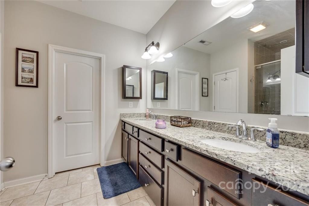 167 Old Carriage Road, Unit 226 Clover, SC 29710 - Photo 23 of 36 a bathroom with a granite countertop double vanity sink and a mirror