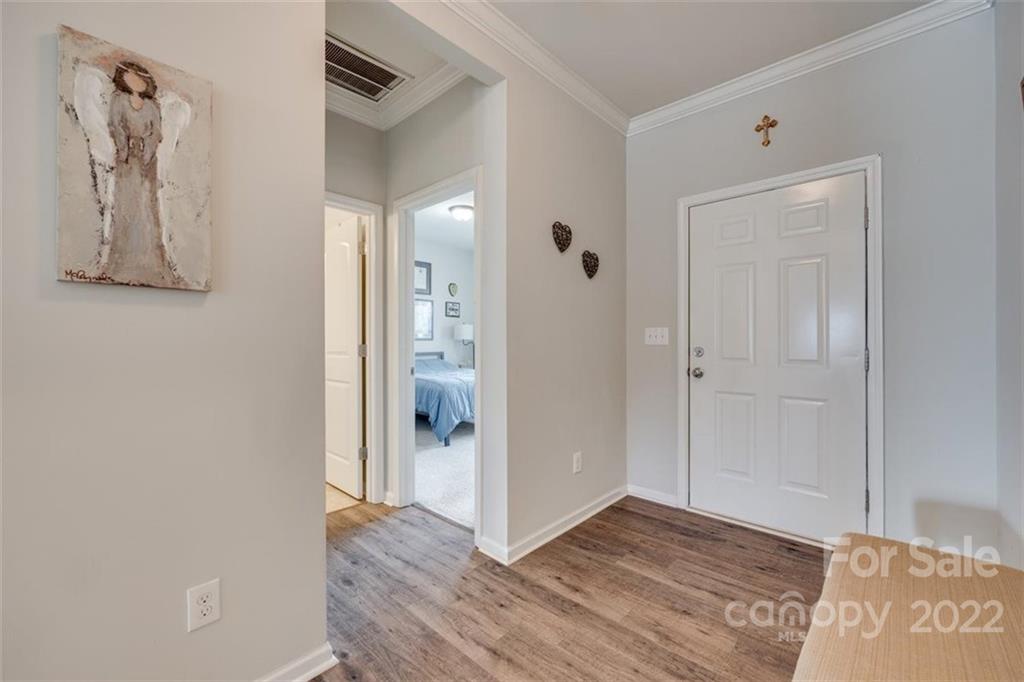 167 Old Carriage Road, Unit 226 Clover, SC 29710 - Photo 3 of 36 a view of a hallway with wooden floor and closet
