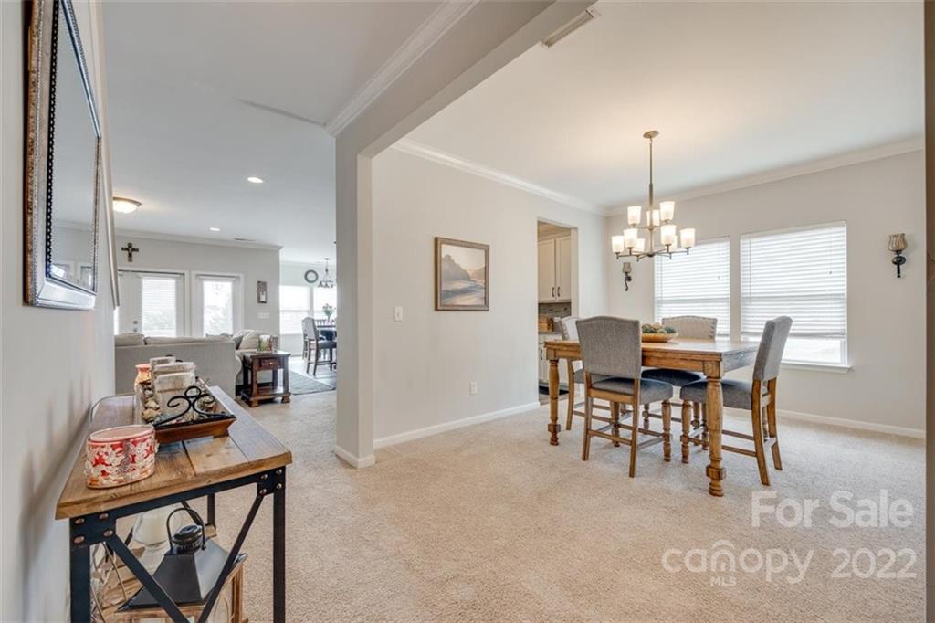167 Old Carriage Road, Unit 226 Clover, SC 29710 - Photo 8 of 36 a view of a dining room with furniture and chandelier