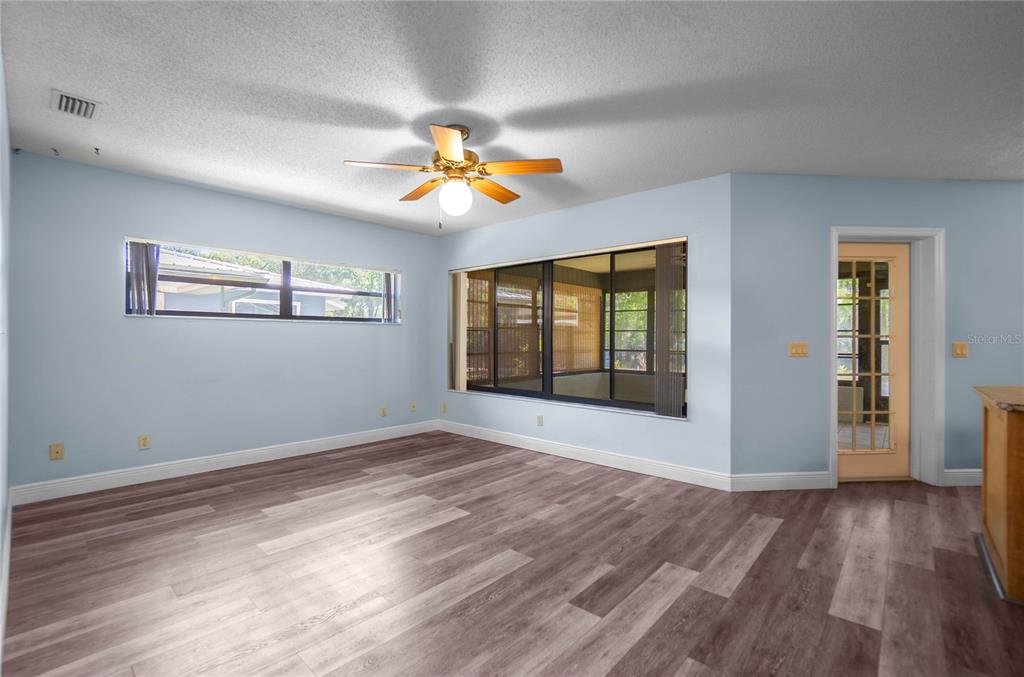 28330 Peterson Camp Road Brooksville, FL 34601 - Photo 13 of 60 a view of an empty room with window and wooden floor