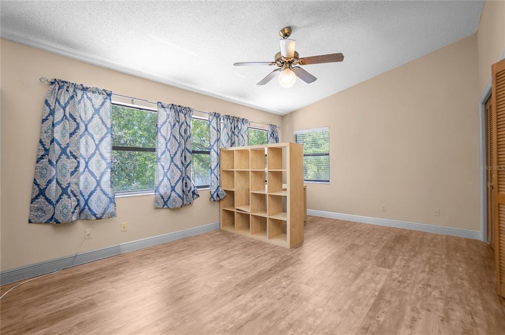 28330 Peterson Camp Road Brooksville, FL 34601 - Photo 24 of 60 a view of an empty room with a window and wooden floor