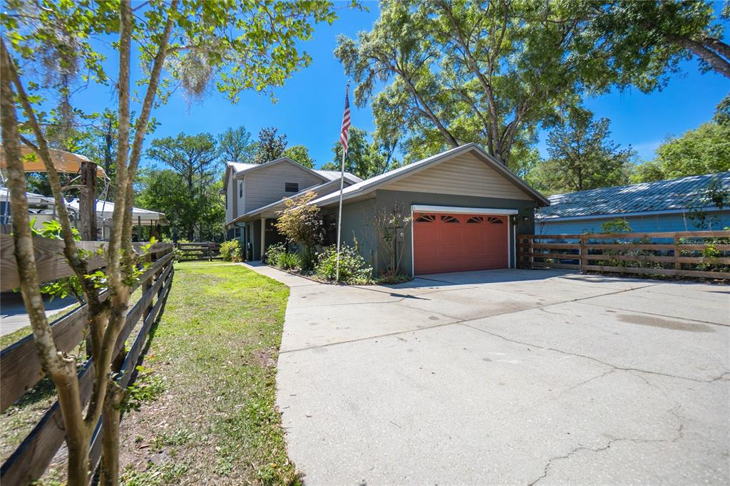 28330 Peterson Camp Road Brooksville, FL 34601 - Photo 3 of 60 a front view of a house with a yard and garage
