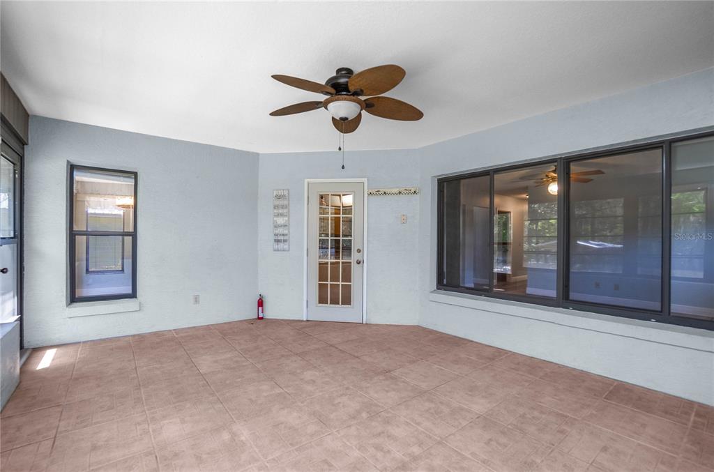 28330 Peterson Camp Road Brooksville, FL 34601 - Photo 31 of 60 a view of an empty room with chandelier fan and windows
