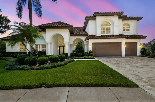 a spacious bathroom with a sink a large mirror a bathtub and next to a window