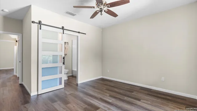 a view of an empty room and wooden floor