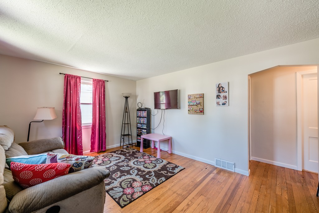 202 Rosewell Street Springfield, MA 01109 - Photo 13 of 25 a living room with furniture and a wooden floor